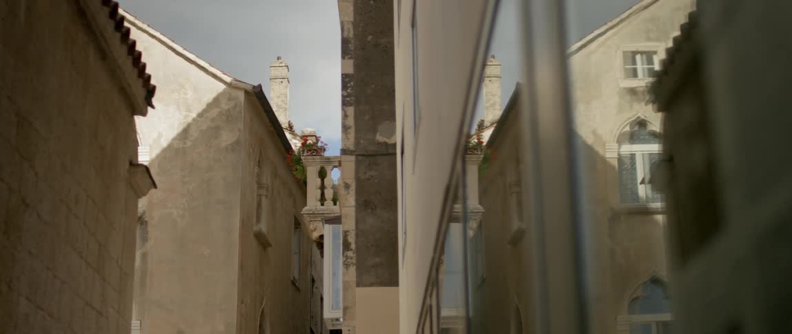 View of an alley between stone buildings