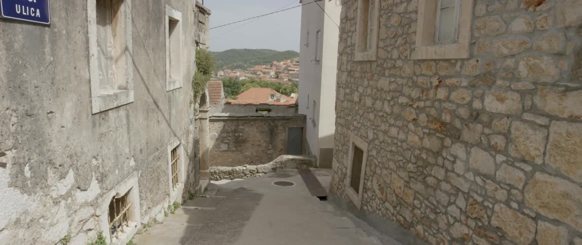The alley between two buildings in the day time