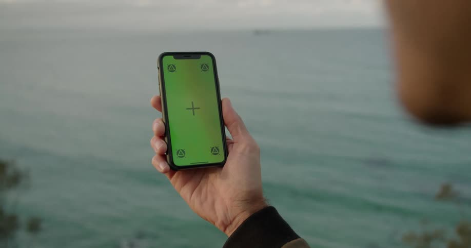 A person is holding their cell phone and talking