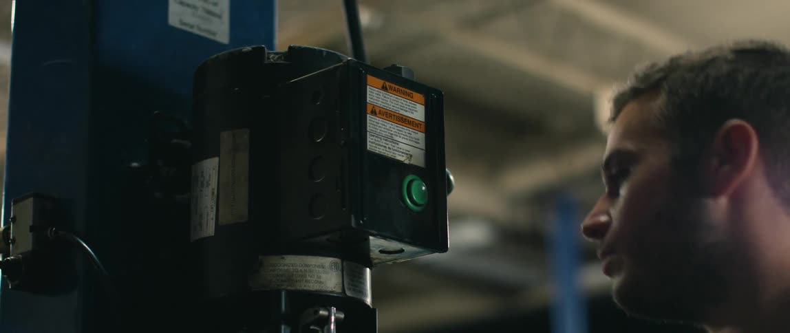 A mechanic presses the button on the lift
