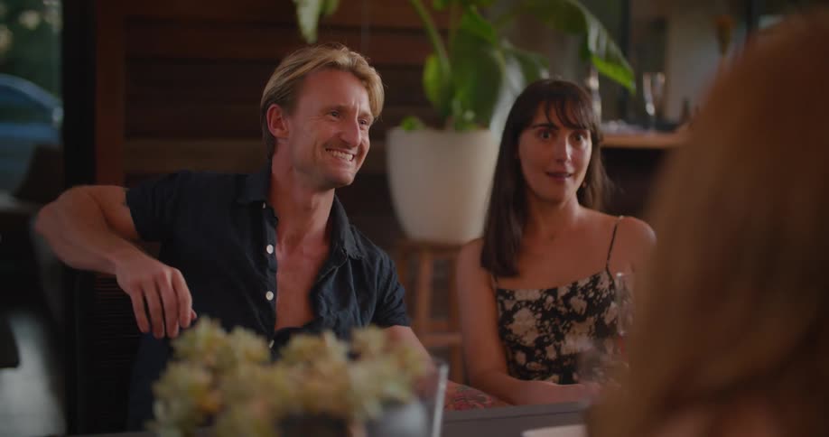 A man and woman sitting around drinking