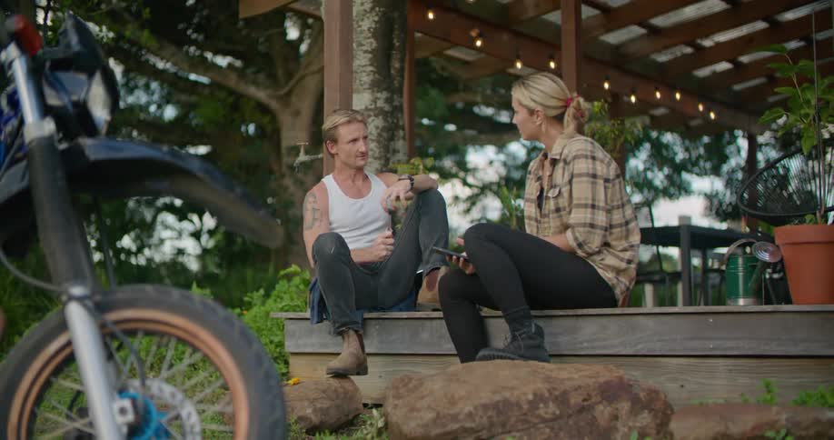 A man and woman sitting outside talking