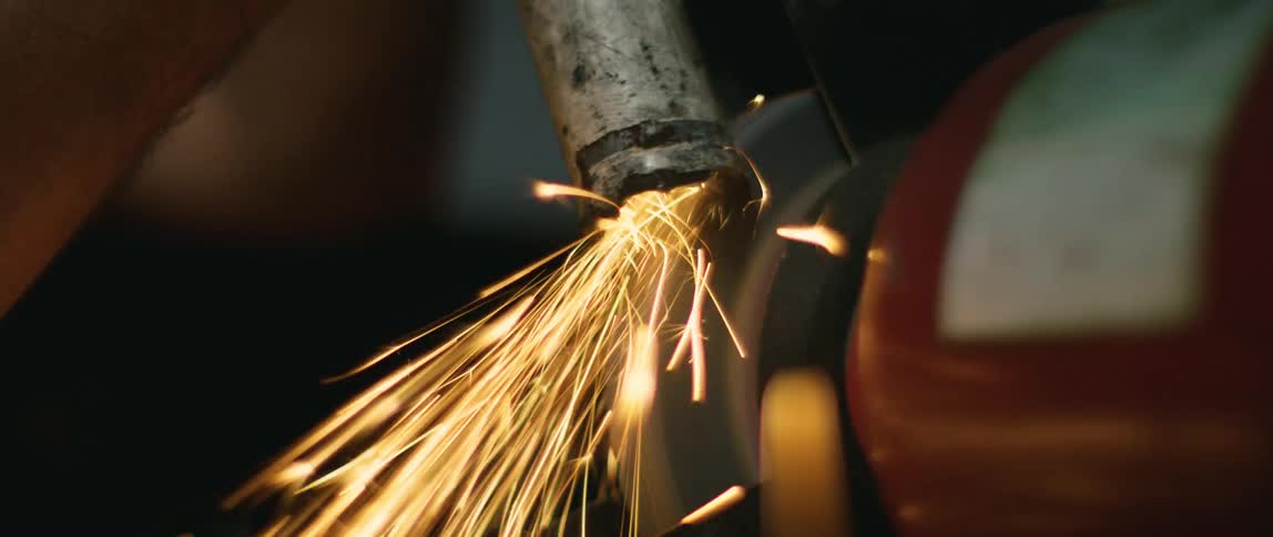 Sparks fly as a person welds metal