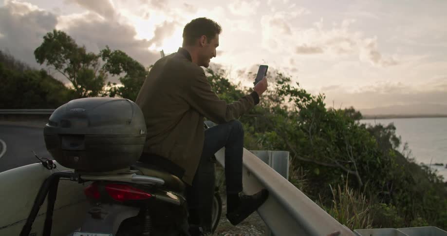 A man standing outdoors with a phone