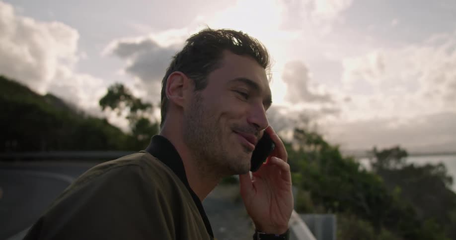 A man talking on a phone outdoors