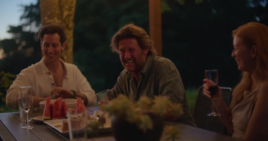Friends have fun outside drinking and having food