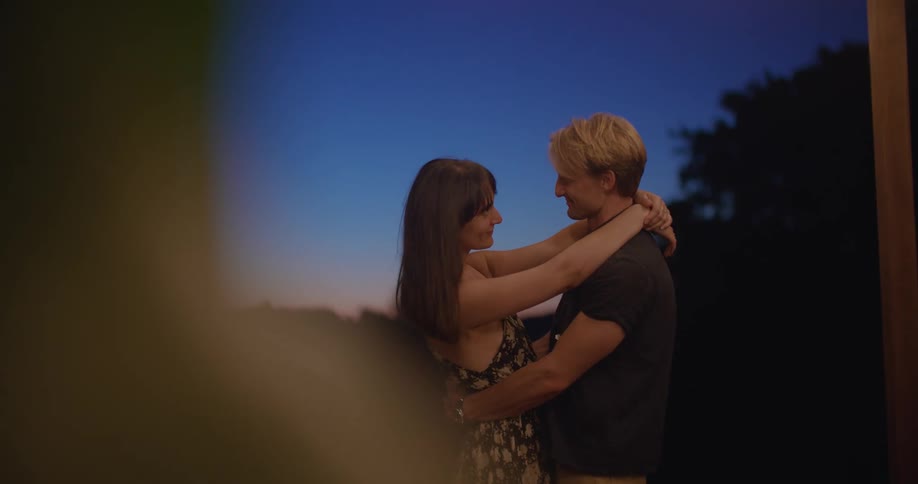 A boyfriend and girlfriend dancing outdoors