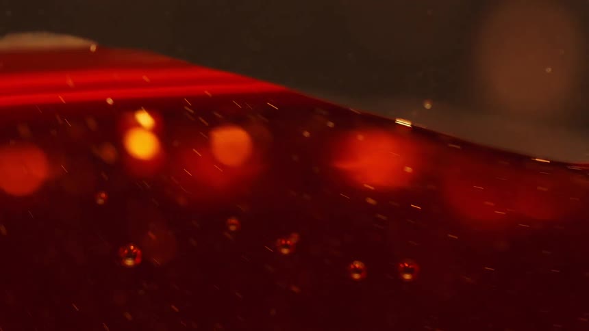 Close up of reddish liquor moving side to side