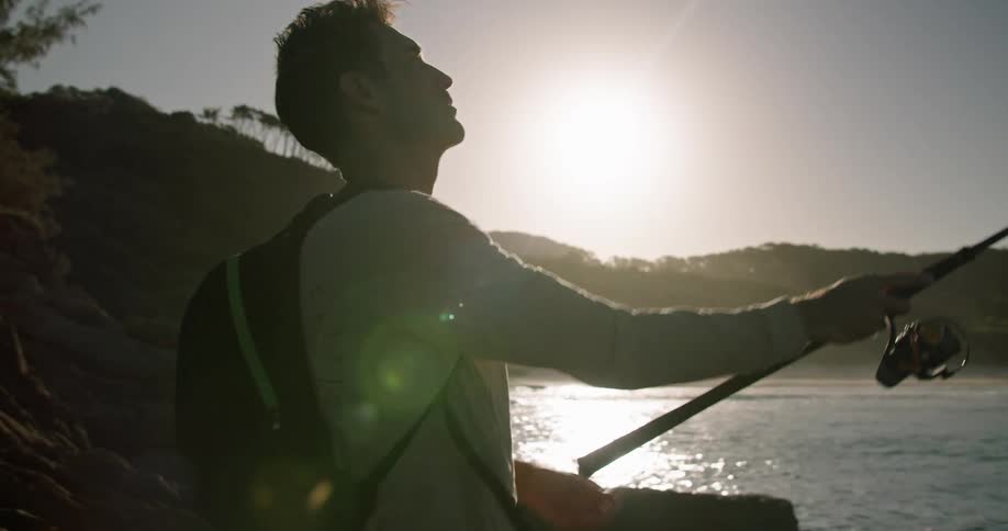 A man fishing outdoors in the ocean