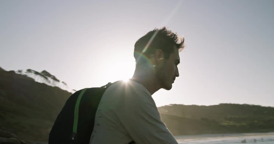 A man is fishing on the shore in the morning