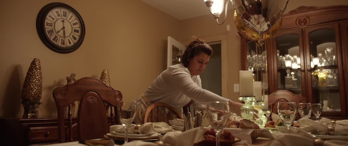 A woman sets a large dining room table