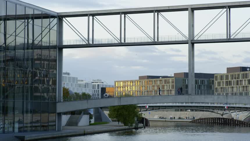 Pedestrians walk over the bridge in the city