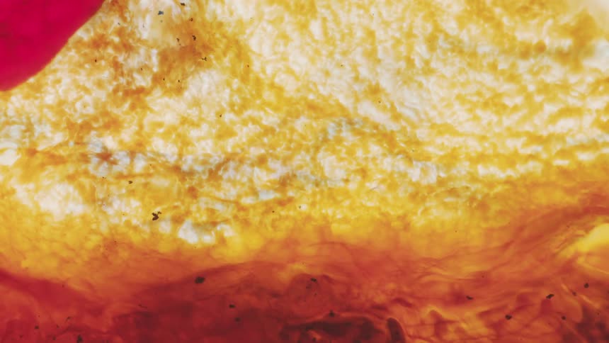 The yellow clouds mix around in the murky liquid