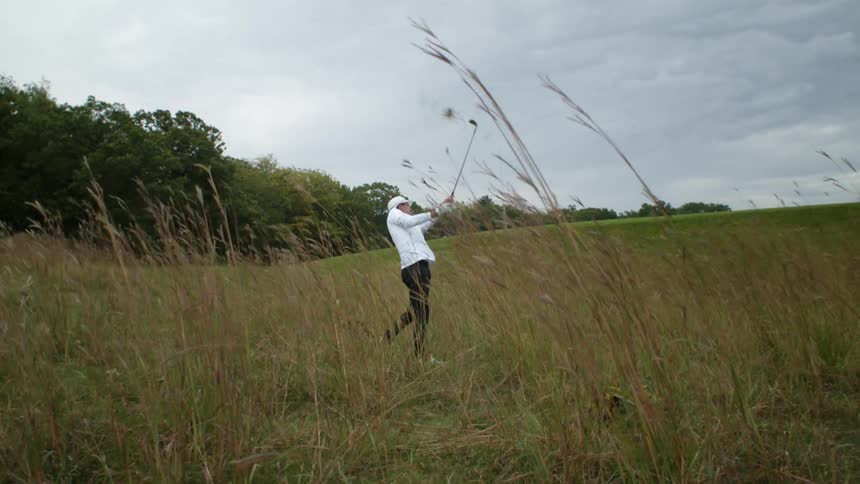 Person golfing outdoors