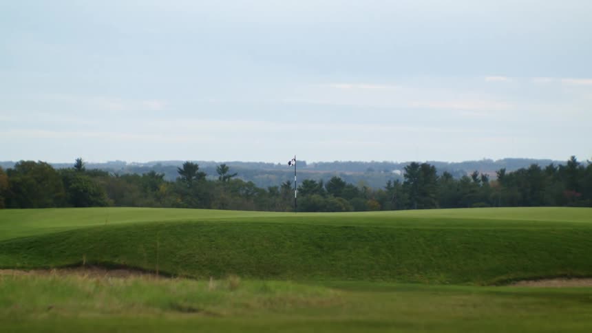 A golf course during the middle of the day