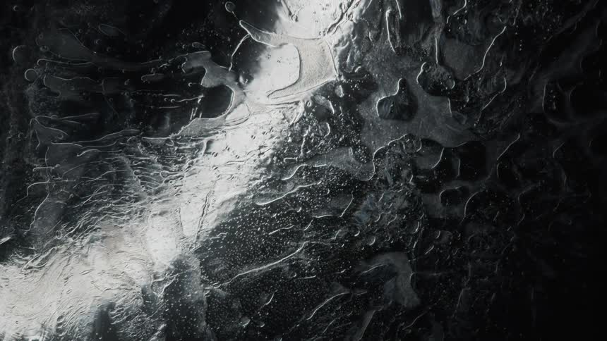 A black and white digital design mimics water and condensation