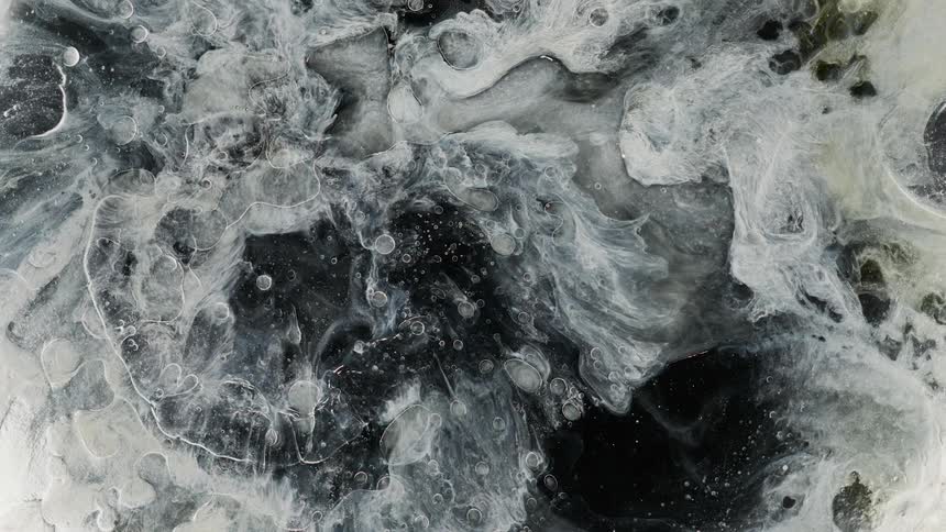 Drops fall and cause waves in the liquid