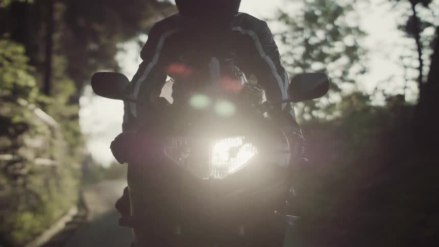 Person riding a motorcycle at sunset