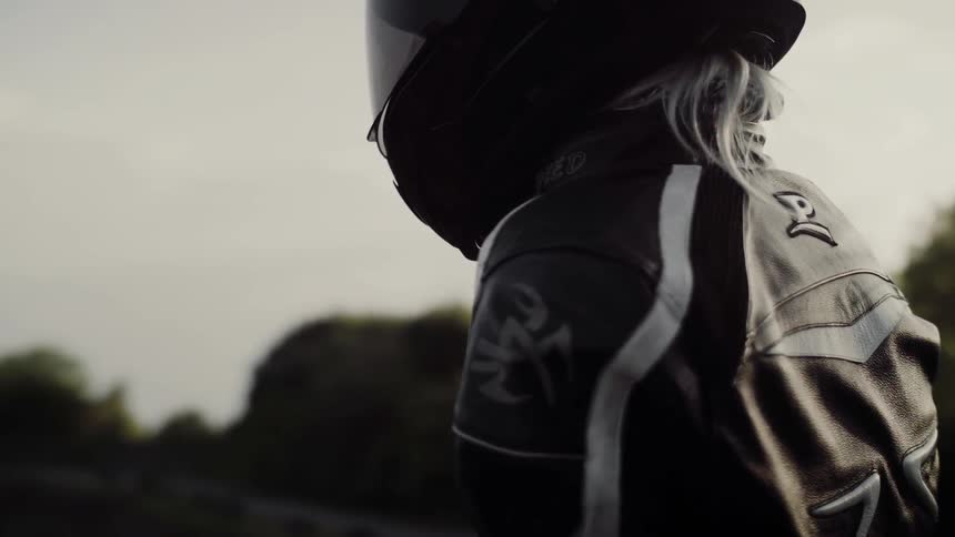 A person wearing a motorcycle helmet is walking