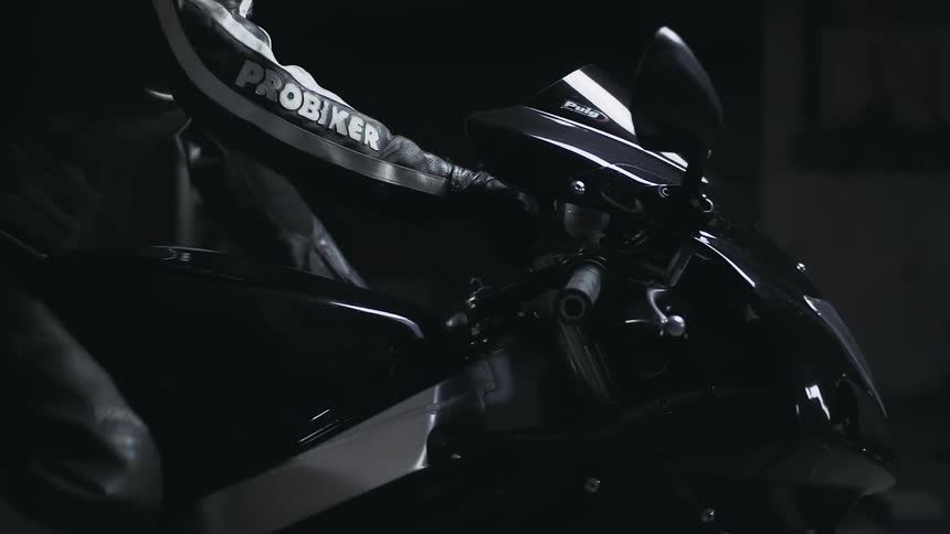 Person climbing onto a motorcycle