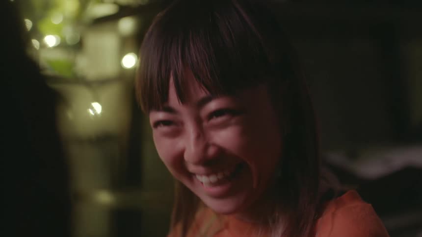 Woman with bangs and straight hair smiles after nodding