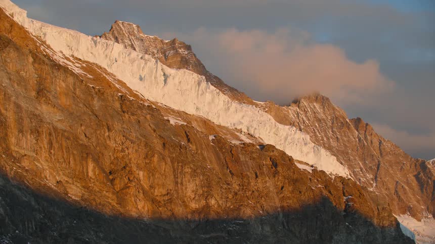 A view of mountains with some snow on them