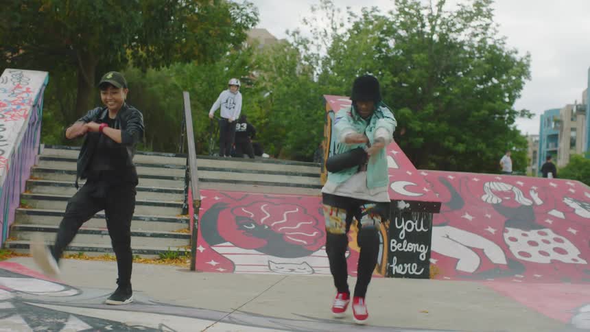 Man and woman dance near stairs and skate park