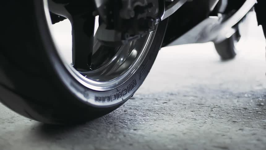 A person moves forward on a motorcycle