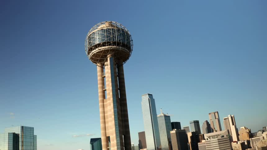 A round building high in the sky and skyscrapers in the distance