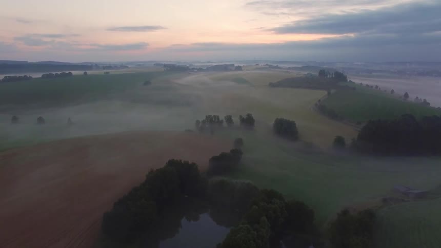 Aerial view of a field covered with fog
