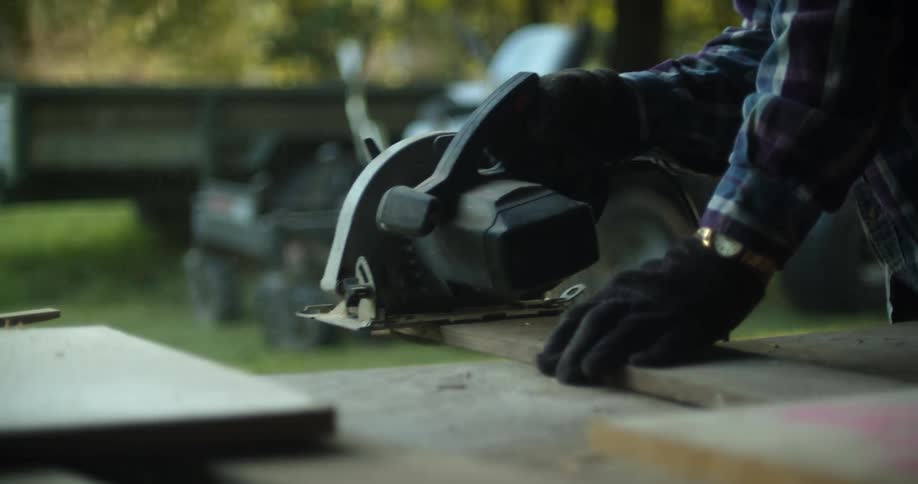 A man sawing a piece of wood