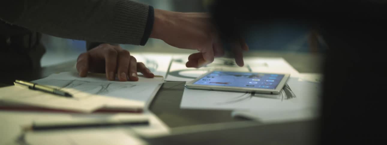 A person drawing out plans on a piece of paper
