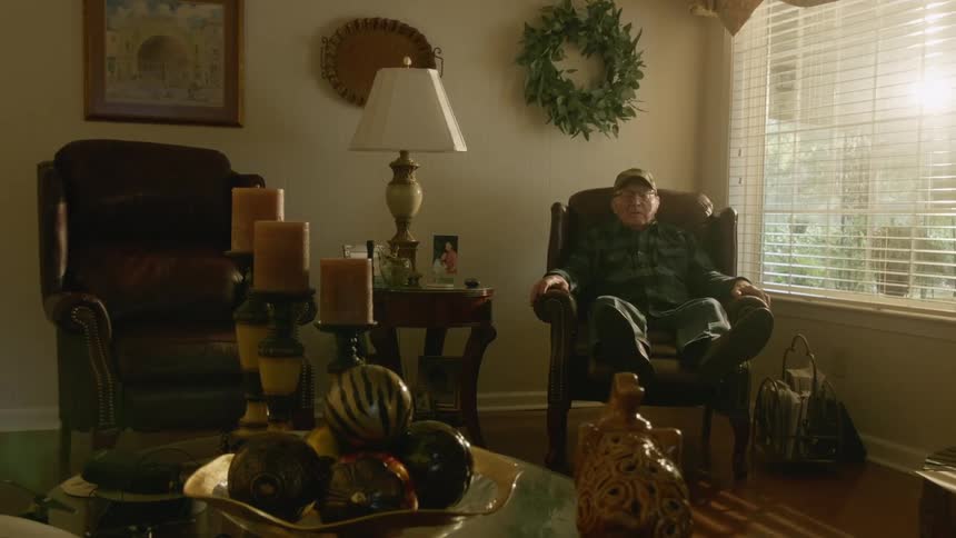 A man sits back in his recliner at home