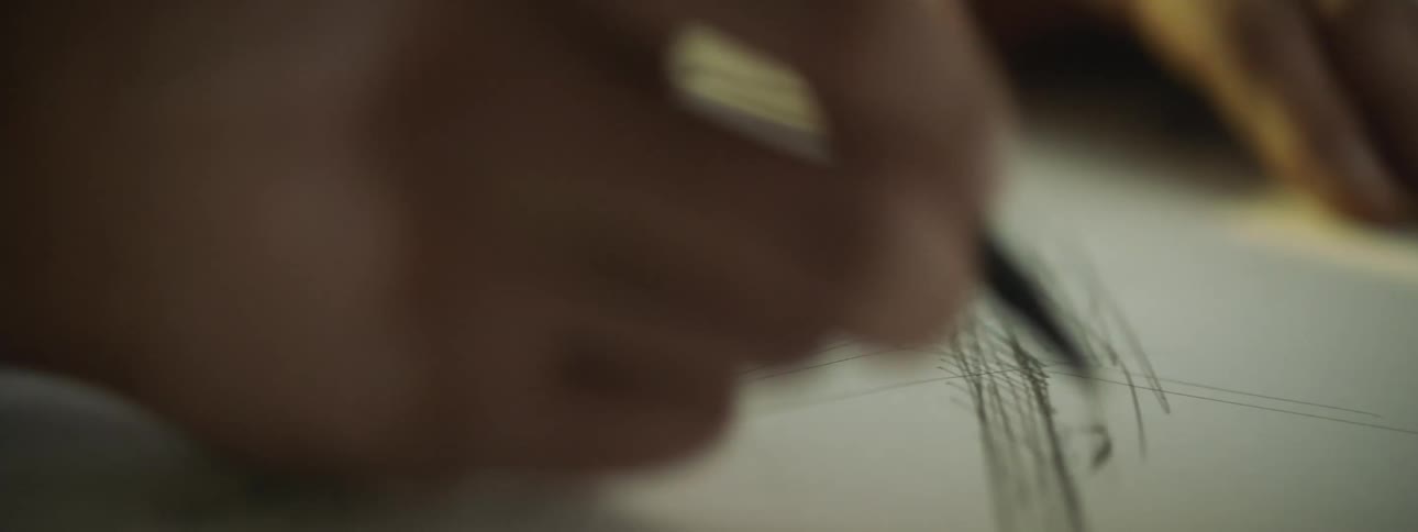 A person sketching on a piece of paper