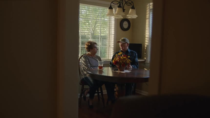 A couple have drinks in the dining room