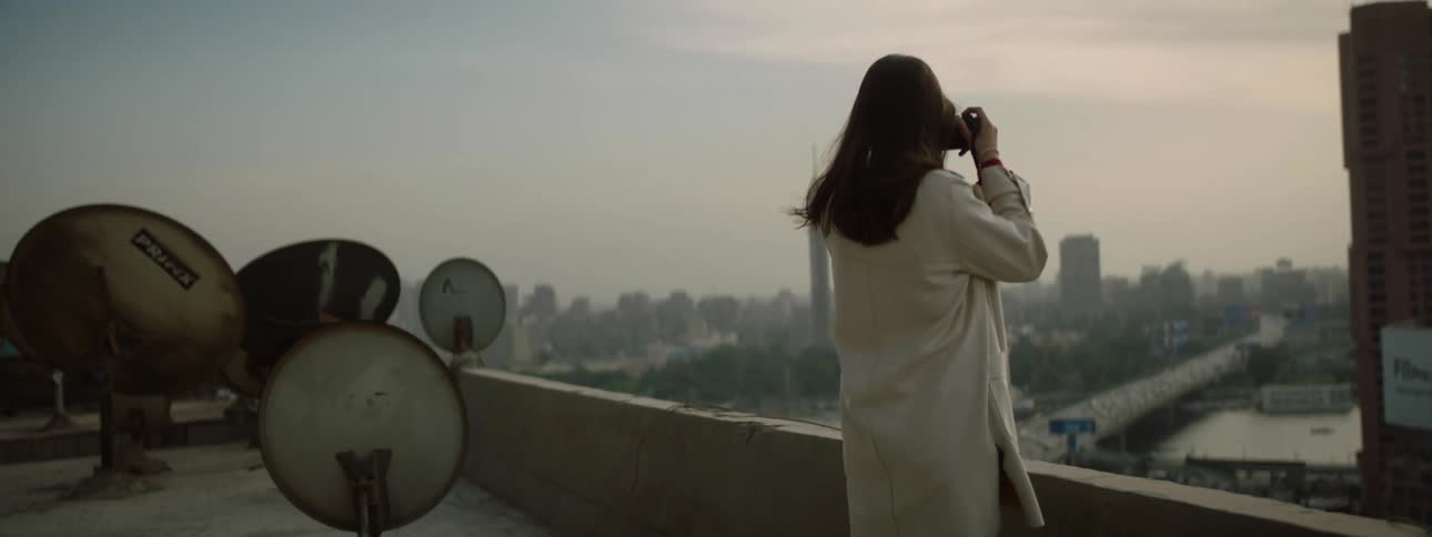 A photographer taking pictures off of a building