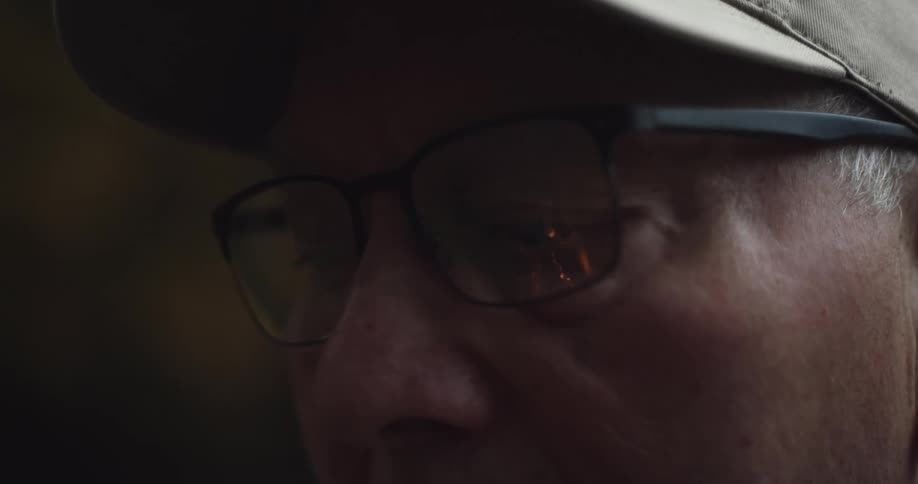 A close up image of a man wearing glasses