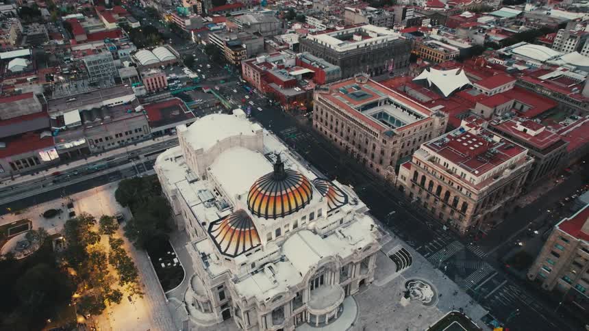An aerial view of the palacio de bellas artes in mexico city with cars traveling past