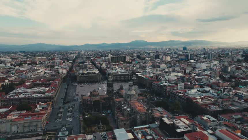 Aerial view of a building with tall spires and surrounding buildings in a city
