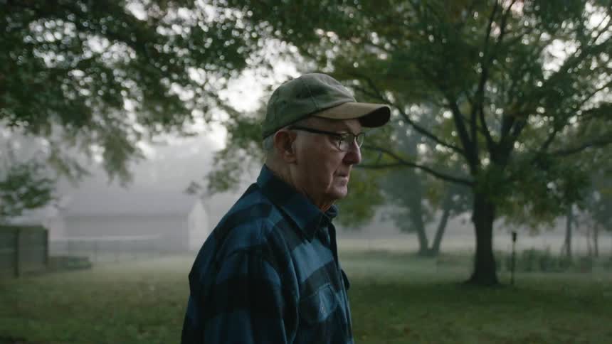 Elderly man walking outdoors at day break