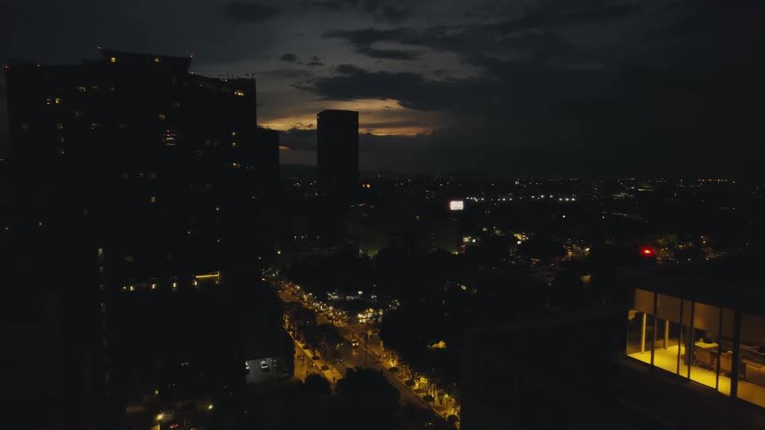 Aerial view of office buildings and highways in the city at dusk