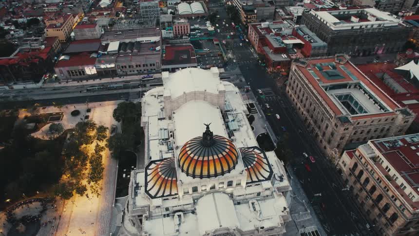 An aerial view of cars driving past buildings in a city