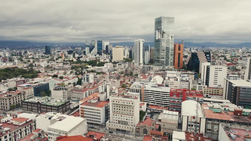 The buildings of a metropolis under a cloudy daytime sky