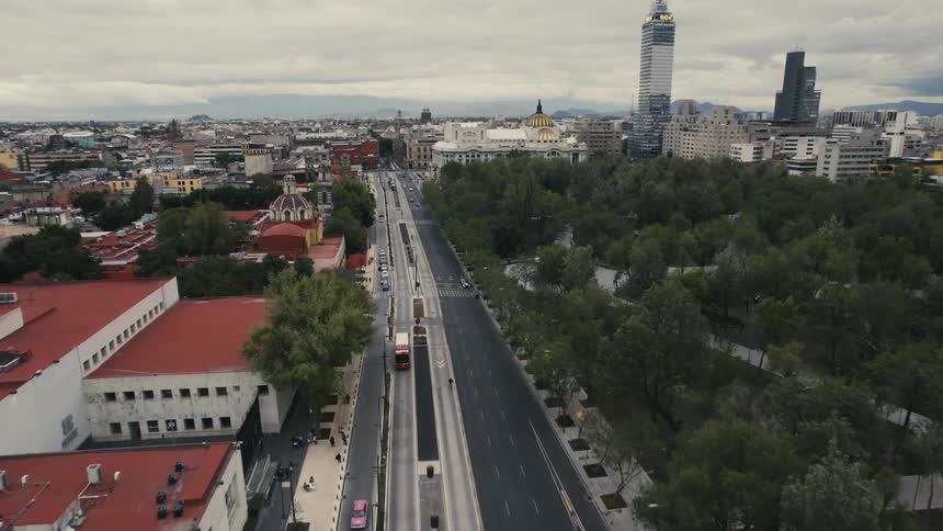 A wide road through a metropolis on a cloudy day