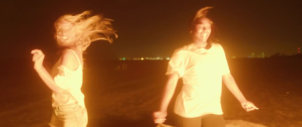 Two women dancing outdoors