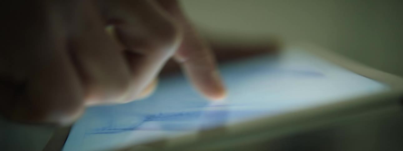 Mans hand touches tablet screen