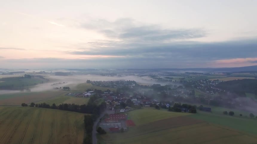 A fog covered city at sunrise