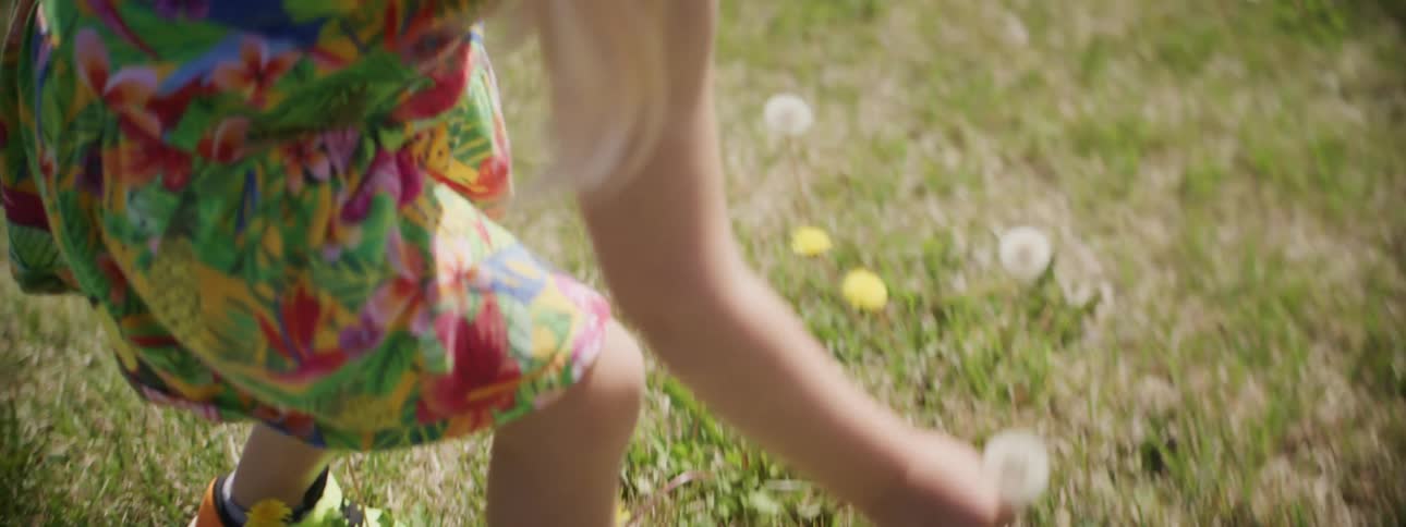 A child picking flowers out in a field