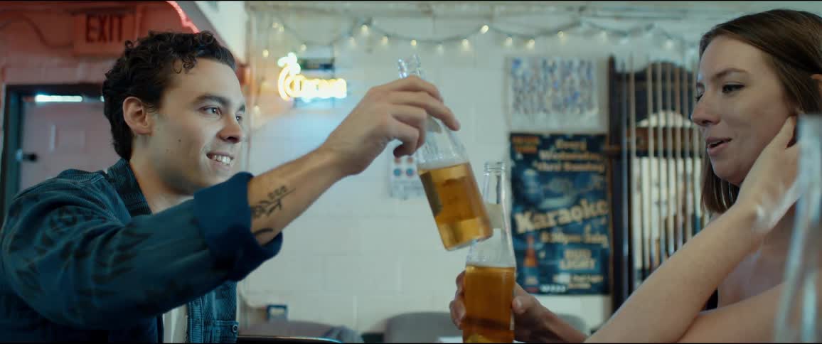 A man and woman drinking at a bar