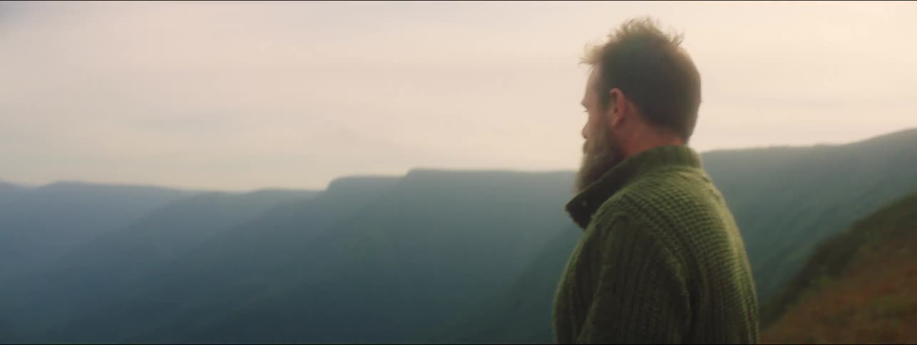 Person on top of mountain looking at view